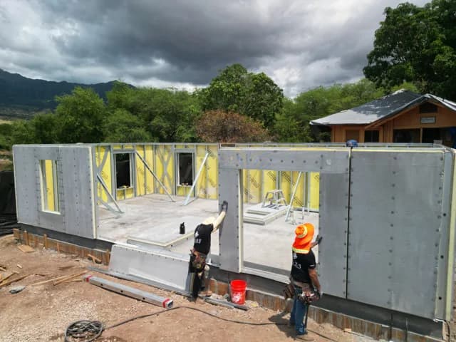 Crew assembling NABS prefabricated steel-frame wall panels on a home in West Oʻahu